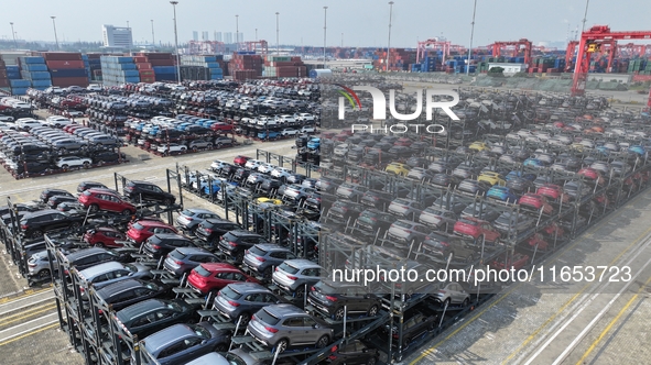 A batch of cars is about to be exported to overseas markets through frame transport at the International Container Terminal in Taicang Port...