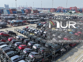 A batch of cars is about to be exported to overseas markets through frame transport at the International Container Terminal in Taicang Port...