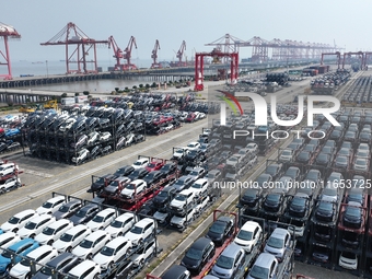 A batch of cars is about to be exported to overseas markets through frame transport at the International Container Terminal in Taicang Port...