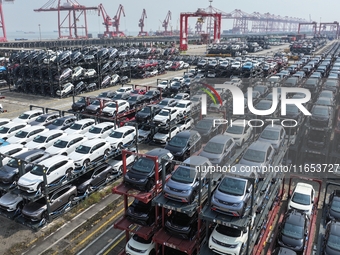 A batch of cars is about to be exported to overseas markets through frame transport at the International Container Terminal in Taicang Port...