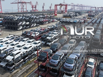 A batch of cars is about to be exported to overseas markets through frame transport at the International Container Terminal in Taicang Port...