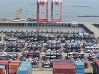 A batch of cars is about to be exported to overseas markets through frame transport at the International Container Terminal in Taicang Port...