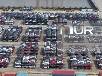 A batch of cars is about to be exported to overseas markets through frame transport at the International Container Terminal in Taicang Port...