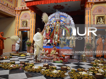 Priests of the Ramakrishna Mission perform a ritual in front of a clay image of the Hindu goddess Durga at Belur Math, about 26 kilometers n...