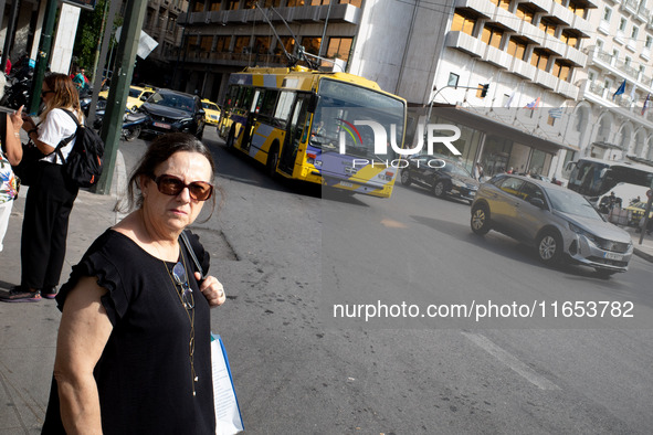 A woman waits for the bus in the center of Athens, Greece, on October 10, 2024. A new measure for public transportation is announced by the...