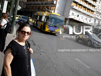 A woman waits for the bus in the center of Athens, Greece, on October 10, 2024. A new measure for public transportation is announced by the...