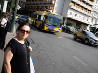 A woman waits for the bus in the center of Athens, Greece, on October 10, 2024. A new measure for public transportation is announced by the...