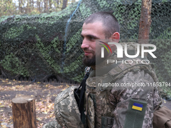 A soldier from a 2S1 Gvozdika self-propelled howitzer crew of Ukraine's 154th Separate Mechanized Brigade is at positions in the Kharkiv reg...