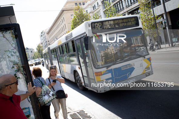 People wait for the bus in the center of Athens, Greece, on October 10, 2024. A new measure for public transportation is announced by the De...