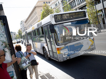 People wait for the bus in the center of Athens, Greece, on October 10, 2024. A new measure for public transportation is announced by the De...