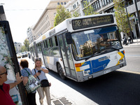 People wait for the bus in the center of Athens, Greece, on October 10, 2024. A new measure for public transportation is announced by the De...