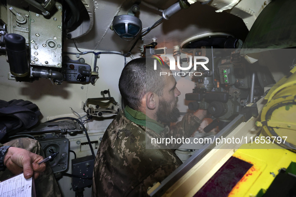 A soldier of Ukraine's 154th Separate Mechanized Brigade is inside a 2S1 Gvozdika self-propelled howitzer at positions in Kharkiv region, no...