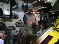 A soldier of Ukraine's 154th Separate Mechanized Brigade is inside a 2S1 Gvozdika self-propelled howitzer at positions in Kharkiv region, no...