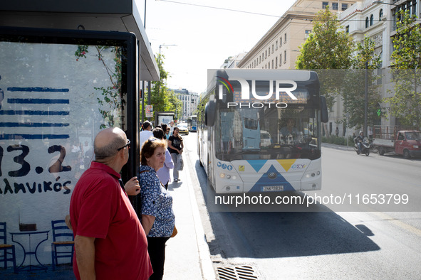 People wait for the bus in the center of Athens, Greece, on October 10, 2024. A new measure for public transportation is announced by the De...