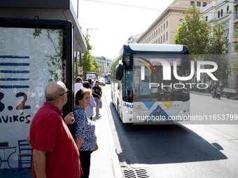 People wait for the bus in the center of Athens, Greece, on October 10, 2024. A new measure for public transportation is announced by the De...