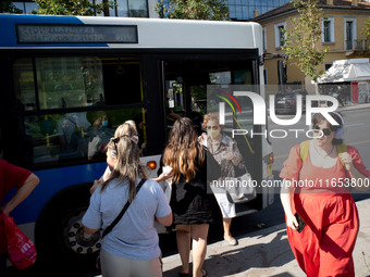 A woman exits the front door of the bus in the center of Athens, Greece, on October 10, 2024. A new measure for public transportation is ann...