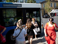 A woman exits the front door of the bus in the center of Athens, Greece, on October 10, 2024. A new measure for public transportation is ann...