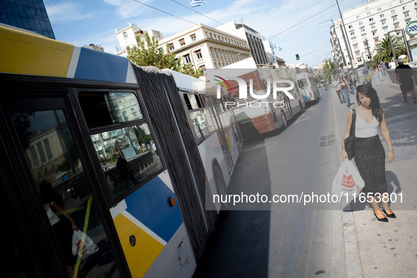 A woman waits for the bus in the center of Athens, Greece, on October 10, 2024. A new measure for public transportation is announced by the...