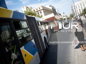 A woman waits for the bus in the center of Athens, Greece, on October 10, 2024. A new measure for public transportation is announced by the...