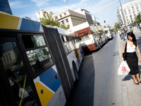 A woman waits for the bus in the center of Athens, Greece, on October 10, 2024. A new measure for public transportation is announced by the...