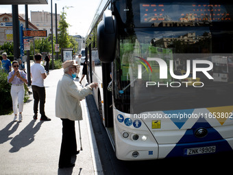 A man waits for the bus in the center of Athens, Greece, on October 10, 2024. A new measure for public transportation is announced by the De...