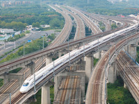 A bullet train runs near Nanjing South Railway Station in Nanjing, China, on October 10, 2024. (