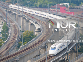 A bullet train runs near Nanjing South Railway Station in Nanjing, China, on October 10, 2024. (