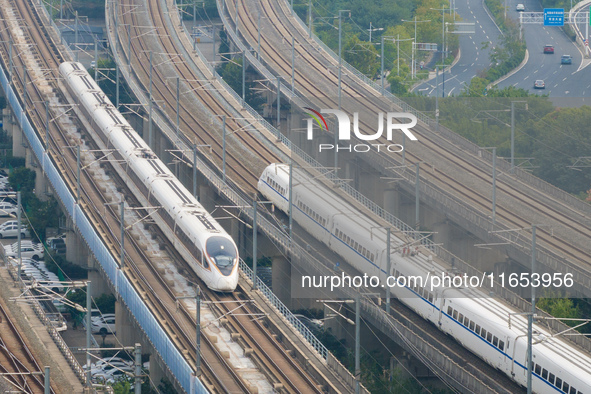 A bullet train runs near Nanjing South Railway Station in Nanjing, China, on October 10, 2024. 