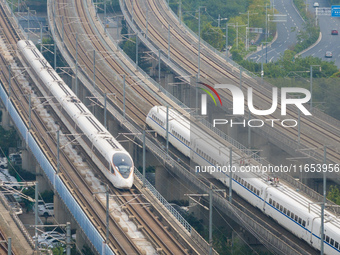 A bullet train runs near Nanjing South Railway Station in Nanjing, China, on October 10, 2024. (