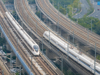 A bullet train runs near Nanjing South Railway Station in Nanjing, China, on October 10, 2024. (