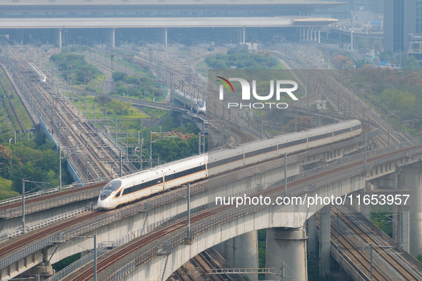 A bullet train runs near Nanjing South Railway Station in Nanjing, China, on October 10, 2024. 