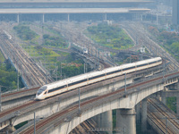 A bullet train runs near Nanjing South Railway Station in Nanjing, China, on October 10, 2024. (