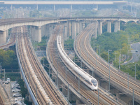 A bullet train runs near Nanjing South Railway Station in Nanjing, China, on October 10, 2024. (