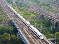 A bullet train runs near Nanjing South Railway Station in Nanjing, China, on October 10, 2024. (