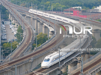 A bullet train runs near Nanjing South Railway Station in Nanjing, China, on October 10, 2024. (