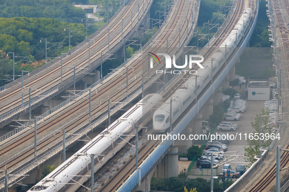 A bullet train runs near Nanjing South Railway Station in Nanjing, China, on October 10, 2024. 