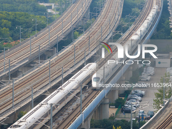 A bullet train runs near Nanjing South Railway Station in Nanjing, China, on October 10, 2024. (