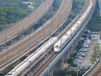 A bullet train runs near Nanjing South Railway Station in Nanjing, China, on October 10, 2024. (