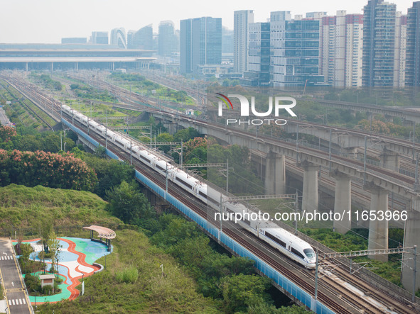 A bullet train runs near Nanjing South Railway Station in Nanjing, China, on October 10, 2024. 