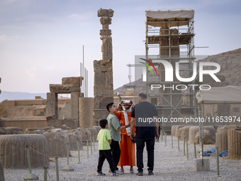 An Iranian woman uses VR glasses while visiting the Persepolis historical site near the city of Shiraz in Fars province, about 932 km (579 m...