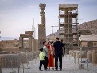 An Iranian woman uses VR glasses while visiting the Persepolis historical site near the city of Shiraz in Fars province, about 932 km (579 m...