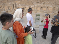 Iranian young boys use VR glasses while visiting the Persepolis historical site near the city of Shiraz in Fars province, about 932 km (579...