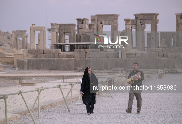 An Iranian couple visits the Persepolis historical site near the city of Shiraz in Fars province, about 932 km (579 miles) south of Tehran,...