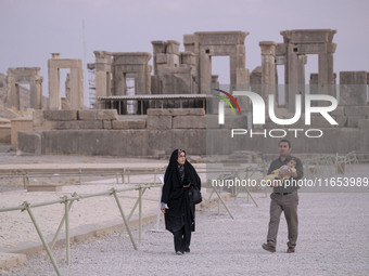 An Iranian couple visits the Persepolis historical site near the city of Shiraz in Fars province, about 932 km (579 miles) south of Tehran,...