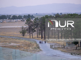 Iranian women walk along a road while visiting the Persepolis historical site near the city of Shiraz in Fars province, about 932 km (579 mi...