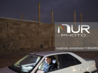 An Iranian man sits in his vehicle at the Persepolis historical site near the city of Shiraz in Fars province, about 932 km (579 miles) sout...