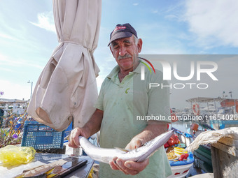 A fisherman is seen in Glyfada in Athens, Greece, on October 10, 2024. (