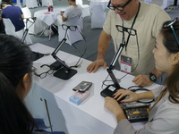 Visitors view AI glasses at the International Consumer Electronics Show in Shanghai, China, on October 10, 2024. (