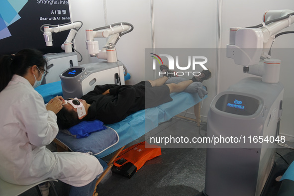 A visitor experiences an intelligent medical robot at the International Consumer Electronics Show in Shanghai, China, on October 10, 2024. 