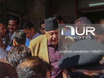 Former chief minister of Jammu and Kashmir and Jammu and Kashmir National Conference (JKNC) party president Farooq Abdullah (Center) stands...